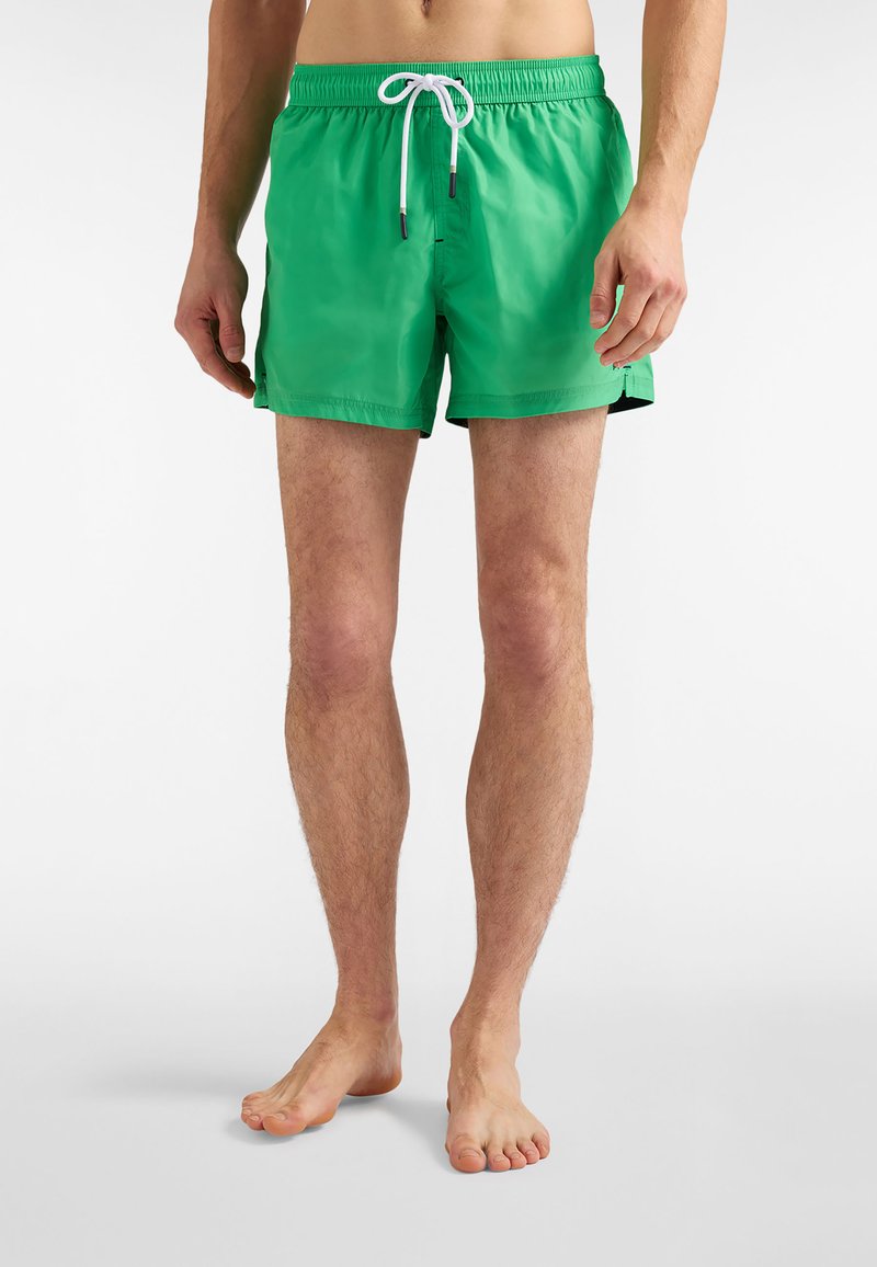 Zelené plavkové šortky vyrobené z ľahkého, hladkého materiálu. Majú elastický pás so šnúrkou, dĺžku nad kolená a bočné vrecká.