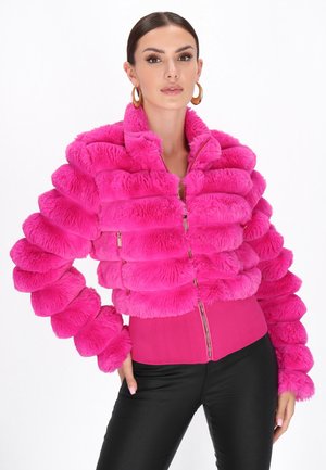 Pink faux fur jacket with puffy, ribbed design, zip front, and a fitted bottom. Paired with black pants, presenting a bold color contrast.