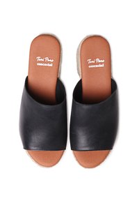 Black leather slides with an open toe design, featuring a light brown insole and a natural woven sole. Smooth texture with minimal detailing.