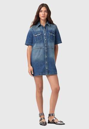 Denim shirt dress with short sleeves, button front, two chest pockets, light and dark blue color gradient, and a straight loose fit.