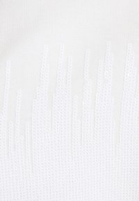 White textured sweater featuring vertical lines of small, reflective sequins. Soft, knitted fabric with a subtle sheen and ribbed details.