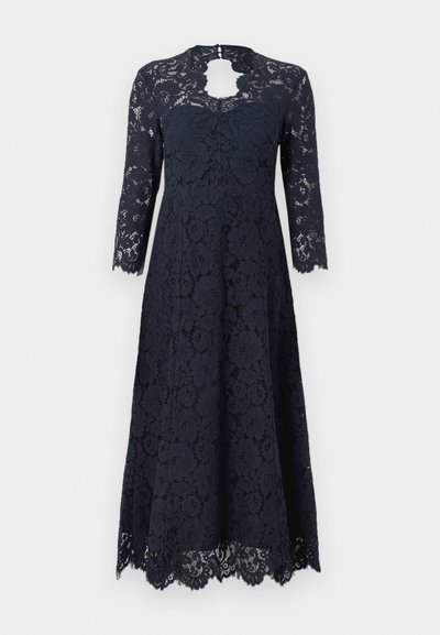 Navy lace dress with long sleeves, floral pattern, scalloped hem, and a keyhole neck cutout; textured fabric enhances visual detail.