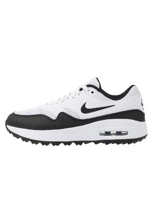 Witte en zwarte Nike Air Max sneaker met mesh bovenwerk, zichtbare luchtkussen in zool en zwart swoosh-logo aan de zijkant tegen witte achtergrond.