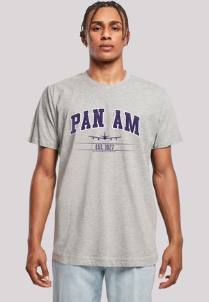 Gray cotton t-shirt featuring "PAN AM" in bold purple letters, with an aircraft graphic and "EST. 1927" beneath. Short sleeves, classic fit.