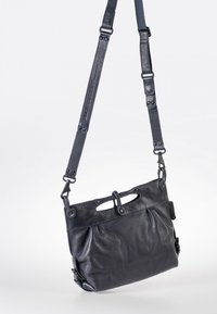 Marineblaue Leder-Umhängetasche mit strukturierten Oberflächen, zwei oberen Tragegriffen, verstellbarem Schultergurt und metallischen Hardware-Details.