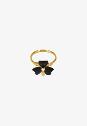 Bague en or avec un motif de fleur noire à trois pétales et un accent en cristal central. Fini métal lisse et gravure de la marque.