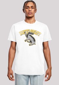 Bílá bavlněná tričko s černou a žlutou grafikou jezevce a nápisem "HUFFLEPUFF" nad ním. Krátké rukávy a design s kulatým výstřihem.