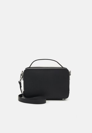 Schwarze Kunstleder-Crossbody-Tasche mit einem oberen Reißverschluss, flachem Design, kurzem Griff und einem abnehmbaren Schulterriemen. Minimalistische Hardwareelemente.