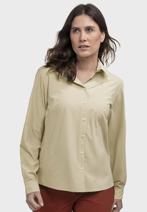 Hellbeiges langärmliges Hemd mit durchgehender Knopfleiste, Kragen und seitlicher Tasche. Glatte Stoffstruktur mit einem dezenten Logo-Detail.