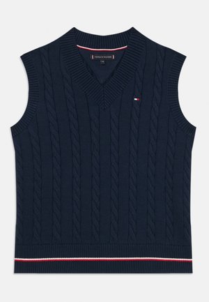 Gilet sans manches bleu marine avec un décolleté en V, présentant une texture en maille torsadée et un ourlet côtelé avec des rayures rouges et blanches.