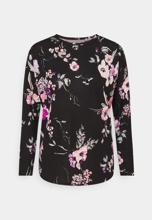 Schwarze Bluse mit langen Ärmeln und rundem Ausschnitt, mit einem Blumenmuster in Pink-, Lila- und Weißtönen, das über den Stoff verteilt ist.