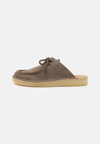 Brown suede slip-on shoes with a rounded toe, stitched detailing, and a light rubber sole. Features laces for a secure fit.