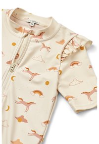 T-shirt de surf à manches courtes, couleur crème, avec des motifs de chevaux roses, d'arcs-en-ciel, de nuages et de soleil. Détail volant sur la manche. Fermeture éclair.