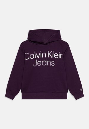 Mørkelilla hættetrøje med lange ærmer og "Calvin Klein Jeans" trykt i store lyse bogstaver på forsiden.