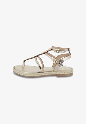 Sandals with a flat sole, featuring metallic and textured straps in beige and gold, and adjustable buckles. Braided rope trim along the sole.