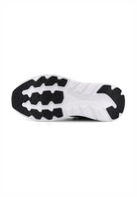 Vit och svart löparskosula med texturerat grepp och geometriskt mönster, sedd från botten mot en vit bakgrund.