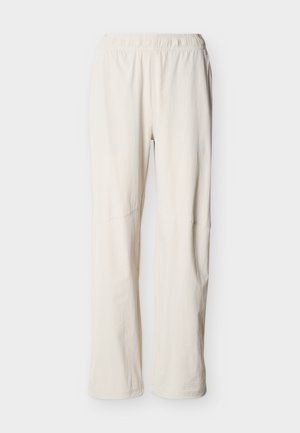 Mimozelené ležérne nohavice s elastickým pásom a priamymi nohavicami, zobrazené na jednoduchom pozadí.