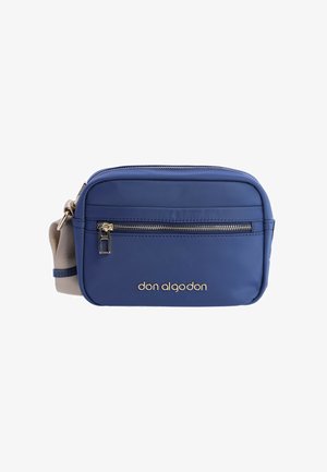 Bolso bandolera azul hecho de tejido resistente, con un bolsillo frontal con cremallera, correa ajustable y detalles en oro con el logo. Forma compacta y rectangular.