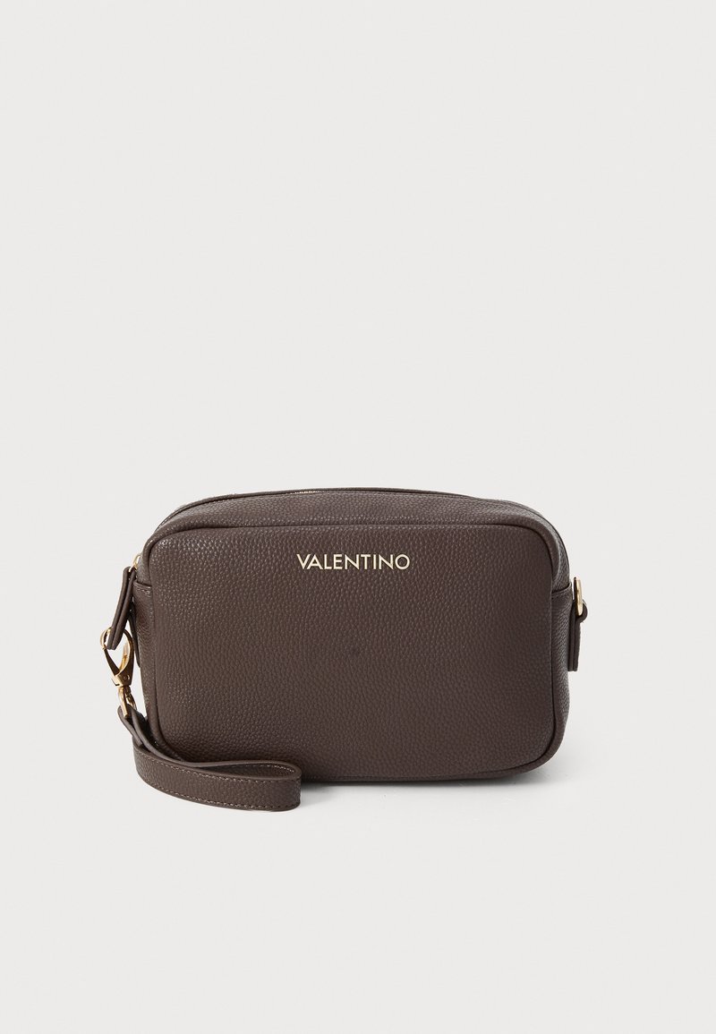 Brown leather crossbody bag with a textured finish, featuring gold branding and a detachable strap for versatility.