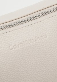 Calvin Klein Jeans ULTRALIGHT SHOULDERBAG - Handbag - eggshell