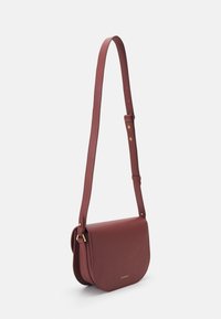 Burgundy leather crossbody bag with a smooth texture, curved flap closure, adjustable strap, and gold hardware accents.