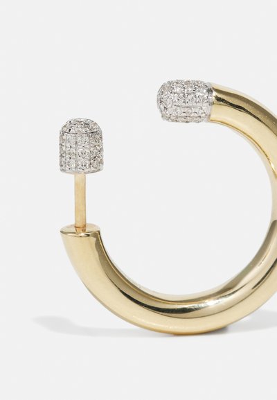 Gold hoop earring with a rounded design, featuring a textured silver accent studded with small clear stones, creating a contrast in materials.