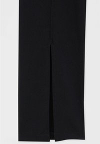 Pantalones negros con una abertura frontal, de textura suave y diseño de pierna recta. La costura es pulcra, destacando la estructura de la prenda.