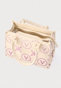 Beige handbag featuring a floral pattern in light purple, two top handles, a zippered main compartment, and gold-toned hardware.