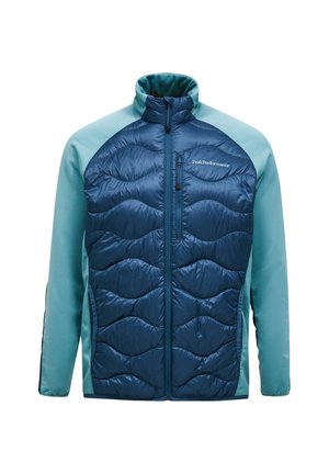 Marineblauer isolierter Mantel mit gestepptem Muster auf der Vorderseite, kontrastierenden hellblauen Ärmeln, hohem Kragen und Reißverschlüssen auf der Brust und an den Seiten.