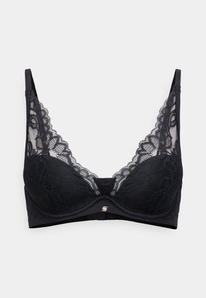 Čierna čipkovaná podprsenka s kostice, zdobená zložitými kvetinovými vzormi, priehľadnými časťami a malým kovovým logom uprostred. Nastaviteľné ramienka.