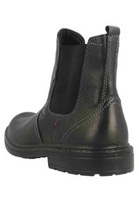 Schwarze Chelsea-Boots aus Leder mit elastischen Seitenteilen, kontrastierender weißer Naht und strukturiertem Finish. Gummisohle für besseren Halt.