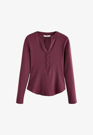 Bordowy long-sleeved top z okrągłym dekoltem, z zapięciem na guziki i prążkowaną teksturą. Hem jest lekko zaokrąglony na dole.