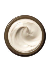 Kremet hvit fuktighetskrem i en brun beholder, som viser en jevn, snurret tekstur. Beholderen har en avrundet form og en blank overflate.