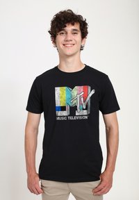 Black cotton t-shirt featuring a distressed MTV logo with colored vertical stripes. Short sleeves and a crew neck design.