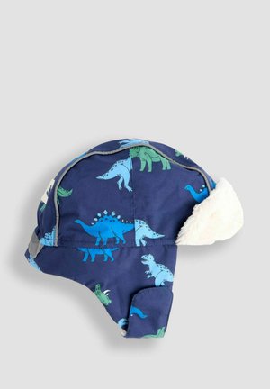 Zils dinozauru raksts ziemas cepure ar mīkstu balto kažokādu iekšpusē, ar noapaļotu formu un ausu uzliktnēm, lai nodrošinātu papildu siltumu.