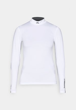 Valge pika varrukaga kõrge kaelusega turtleneck särk venivast kangast. Omab musta logo krael ja musti aktsente varrukatel.