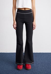 Puma - DARE TO TEXTURED FLARED  - Tracksuit bottoms - black Thumbnail Image 1