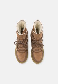 Brown suede ankle boots with a soft beige lining, round toe, and gold hardware on laces. Textured rubber sole for grip.