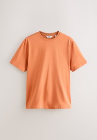 Kurzärmeliges T-Shirt aus weichem, leichtem Stoff. Einfarbig in gebranntem Orange mit Rundhalsausschnitt und geradem Saum. Minimalistisches Design, ohne Muster oder Verzierungen.