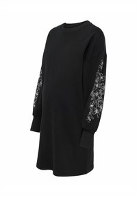 Mustast dressist päevitusega pikkade õhukeste varrukatega pusa, mille varrukatel on valged lilleornamendid, ümara kaelusega ja lõdva istuvusega.