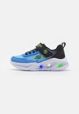 Blue athletic shoe with black accents, textured upper, adjustable strap, and light-up sole featuring stars in green and blue.