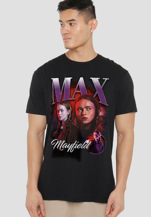Young man wearing black T-shirt featuring three images of same woman with braids, text "MAX Mayfield" in purple and white.