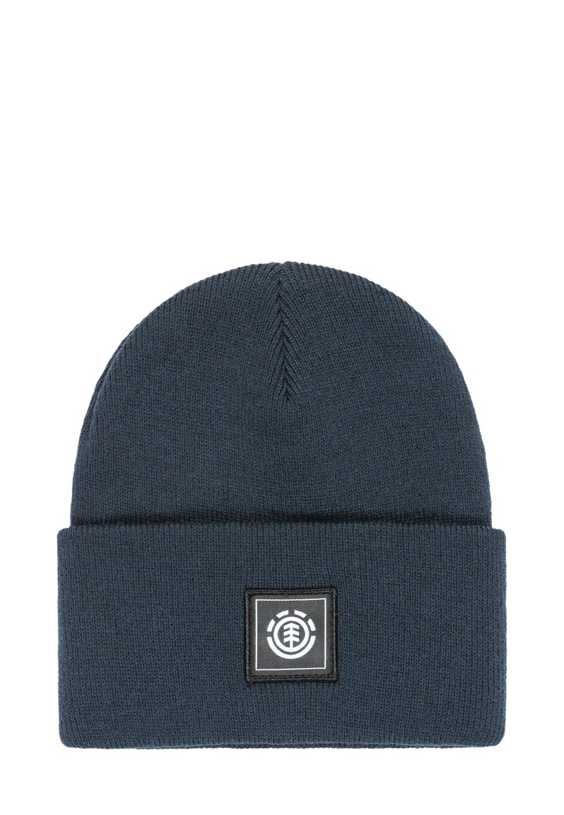 Donkerblauwe gebreide beanie met een omgevouwen rand, voorzien van een vierkante logo-label met zwart-witte accenten. Zachte textuur, ronde bovenkant.