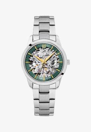 Srebrna kovinska ročna ura z zelenim številčnico, zlatimi kazalci ur in rok ter vidnimi mehanskimi zobniki znotraj številčnice.