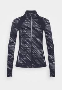 Långärmad idrottsjacka i marinblått med abstrakta grå mönster. Har en hög krage och hel dragkedja. Tillverkad av elastiskt tyg.