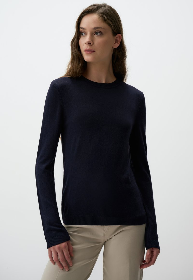 Maglione a maniche lunghe blu navy con collo a giro, realizzato in un tessuto morbido; presenta polsini a coste e una silhouette slim fit.