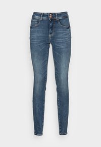 Jeans skinny de denim azul con una cintura de media altura, dos bolsillos delanteros, diseño minimalista y detalles sutiles de costura en las costuras.