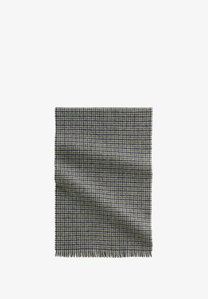 Spleciony koc w żółto-granatowy wzór z pawim kółkiem. Posiada frędzlowe krawędzie i miękką teksturę. Prostokątny kształt.