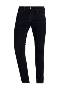 Mörkblå denimjeans med slim fit, med kopparnitar, kontrasterande sömmar och design med fem fickor. Slät textur.