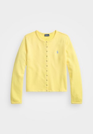 Gul långärmad cardigan i mjuk bomull. Har rund halsringning, framknäppning med silverfärgade tryckknappar och en liten blå logotyp.
